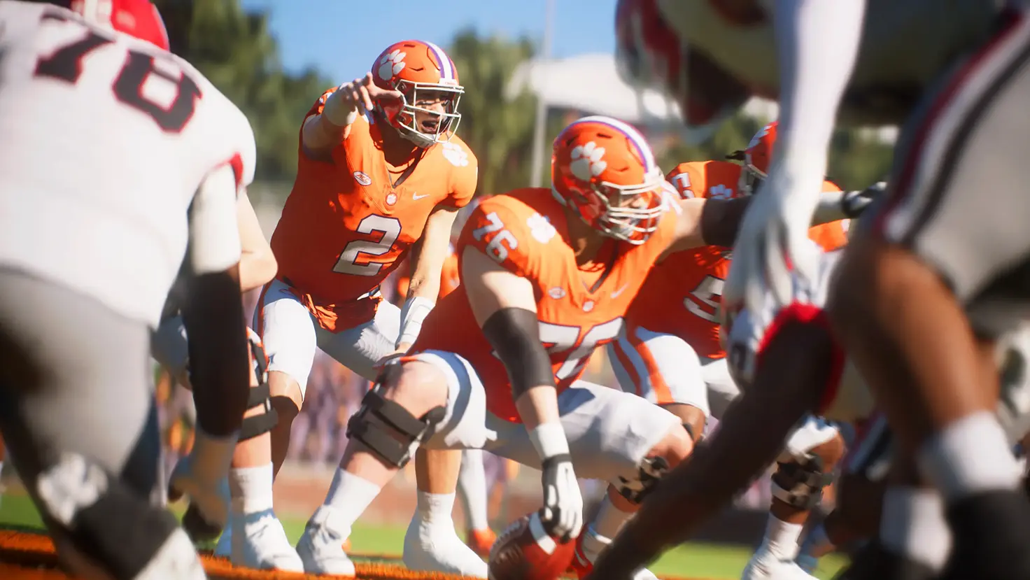 A player in EA Sports College Football 25 prepares for the snap at the line of scrimmage.