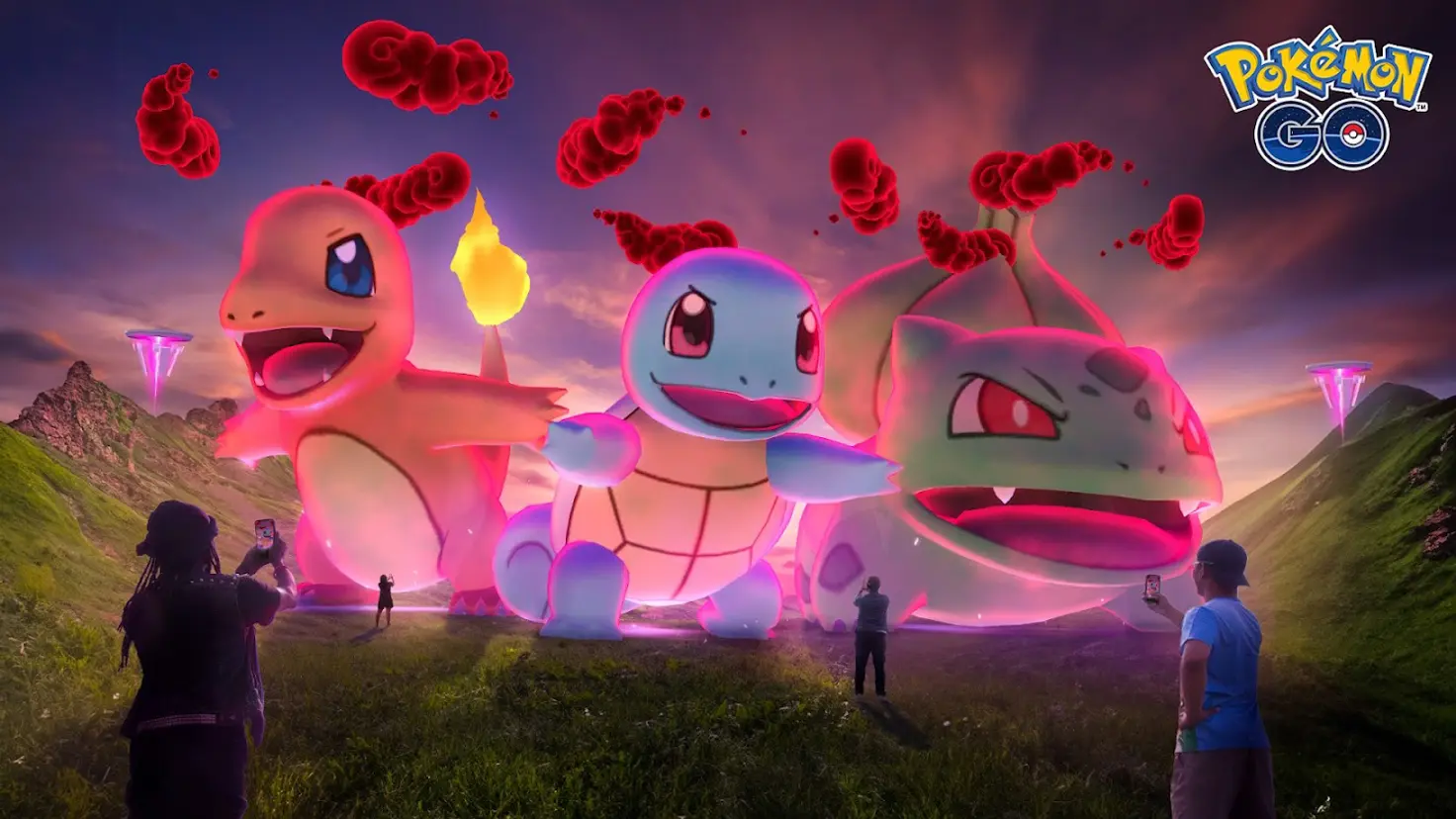 Dynamax Charmander, Squirtle, and Bulbasaur stand in a grassy valley with multiple trainers pointing their phones at them