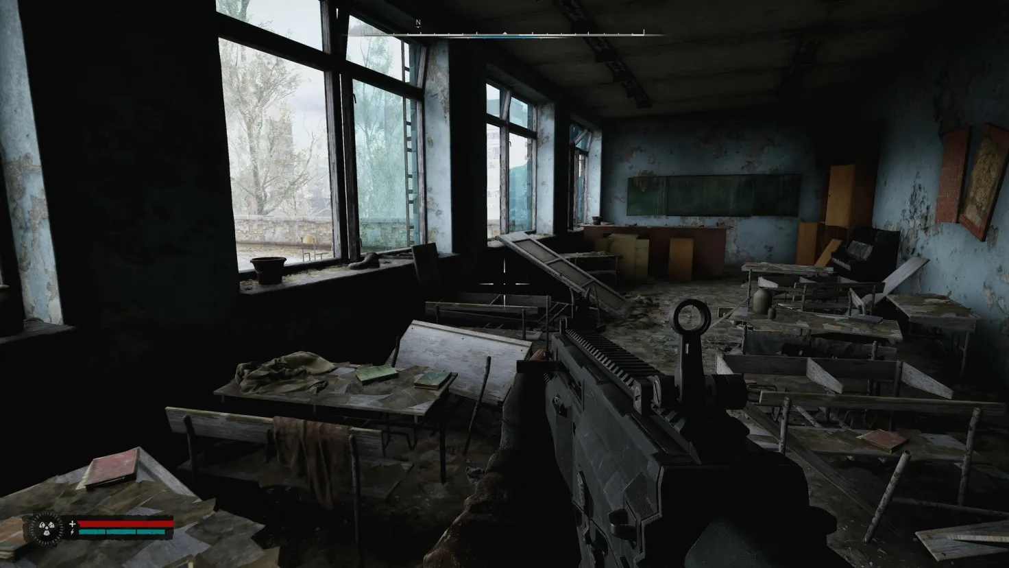 The player aims their gun in an abandoned classroom in Stalker 2: Heart of Chornobyl