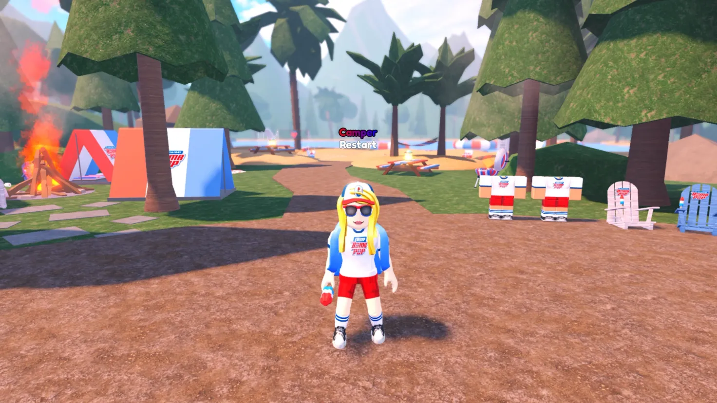 A female Roblox avatar stands in a summer camp environment facing the viewer while wearing Bomb Pop-themed clothing and holding a Bomb Pop in her right hand