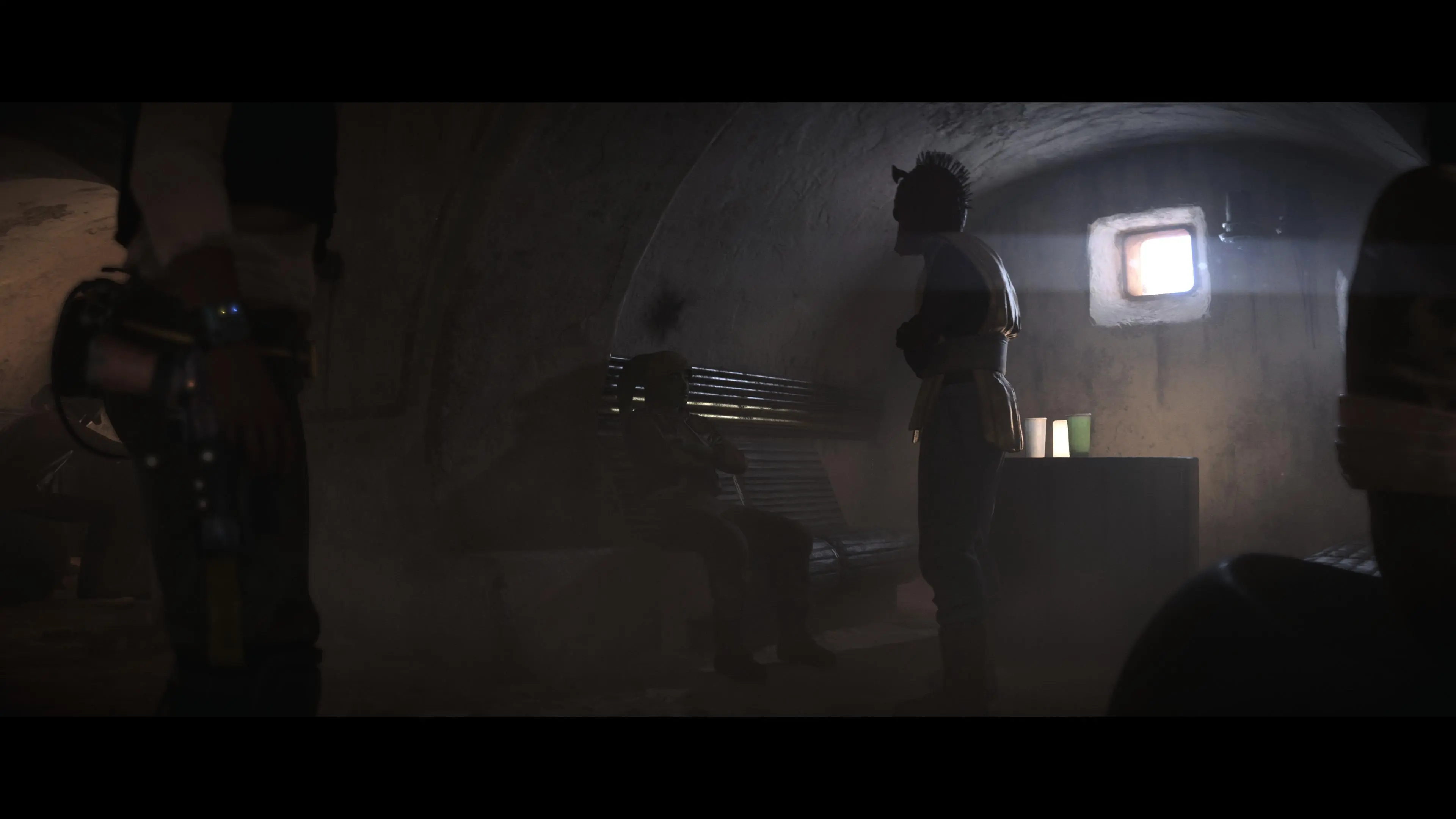 Kay stands by the booth in a cantina where Han Solo shot Greedo