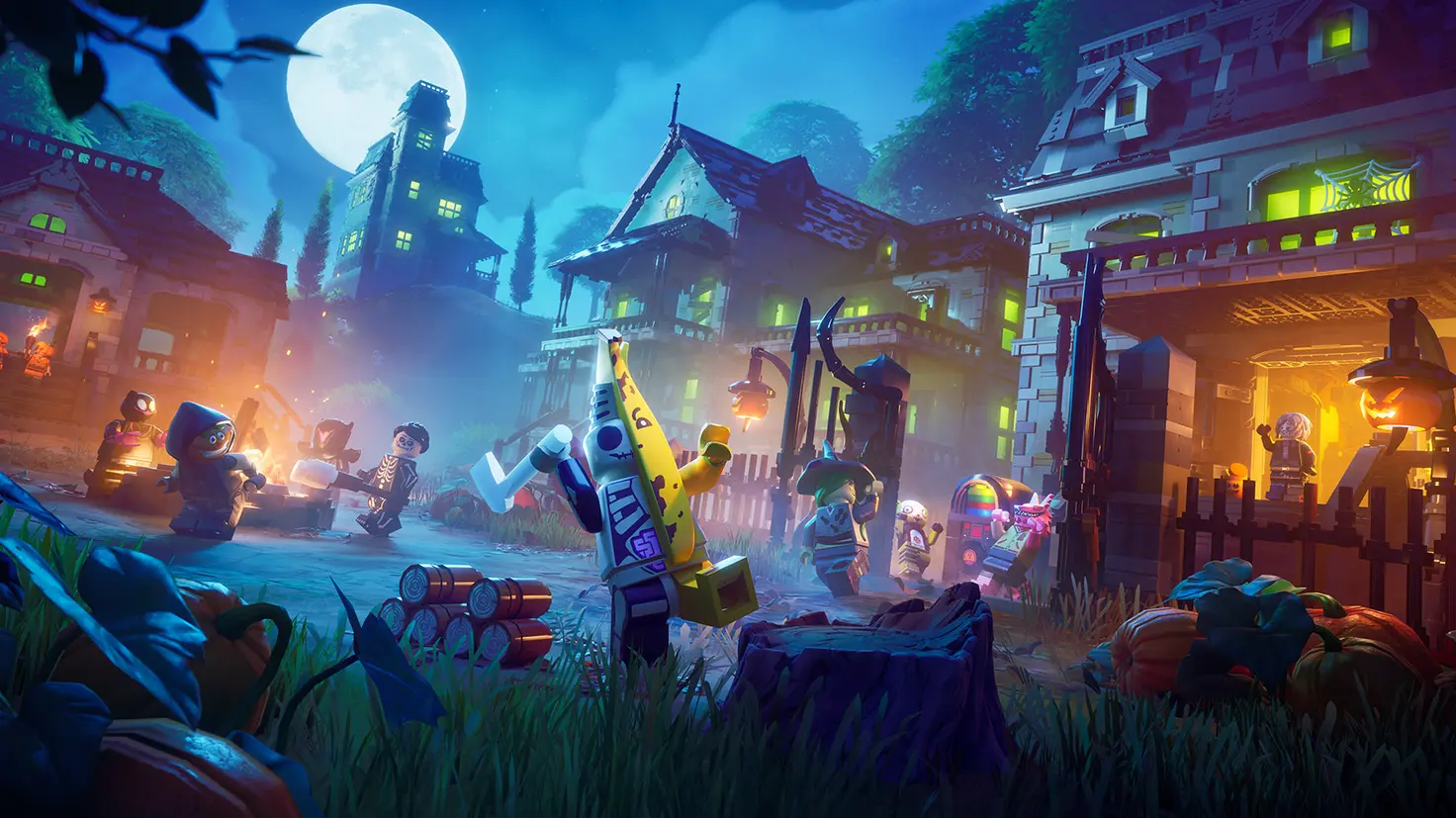 A Halloween-themed town at night in the Lego Fortnite video game. The full moon is behind.