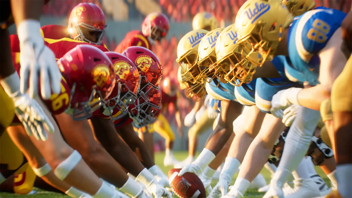 Two college football teams face off at the line of scrimmage during a football game