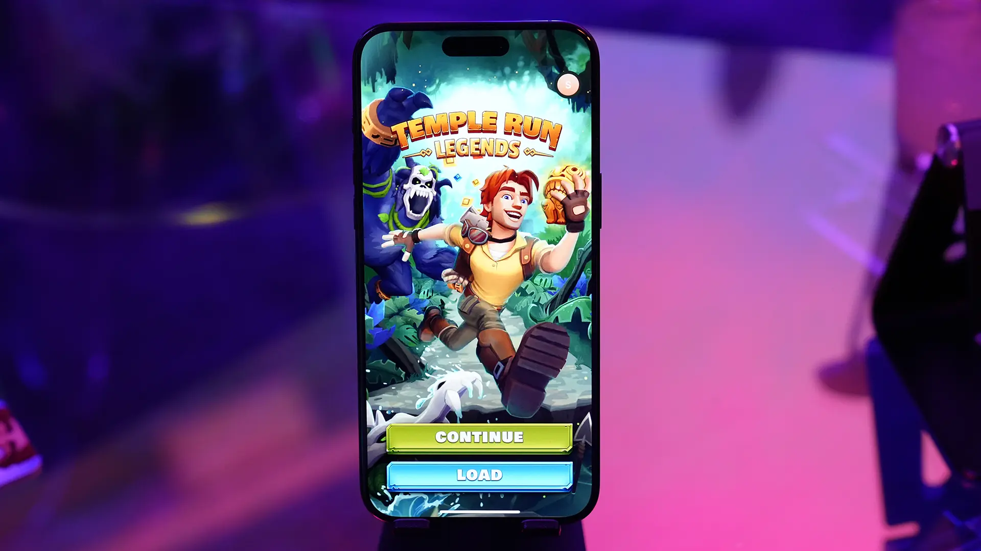 An iPhone displaying the main menu in the Temple Run: Legends video game