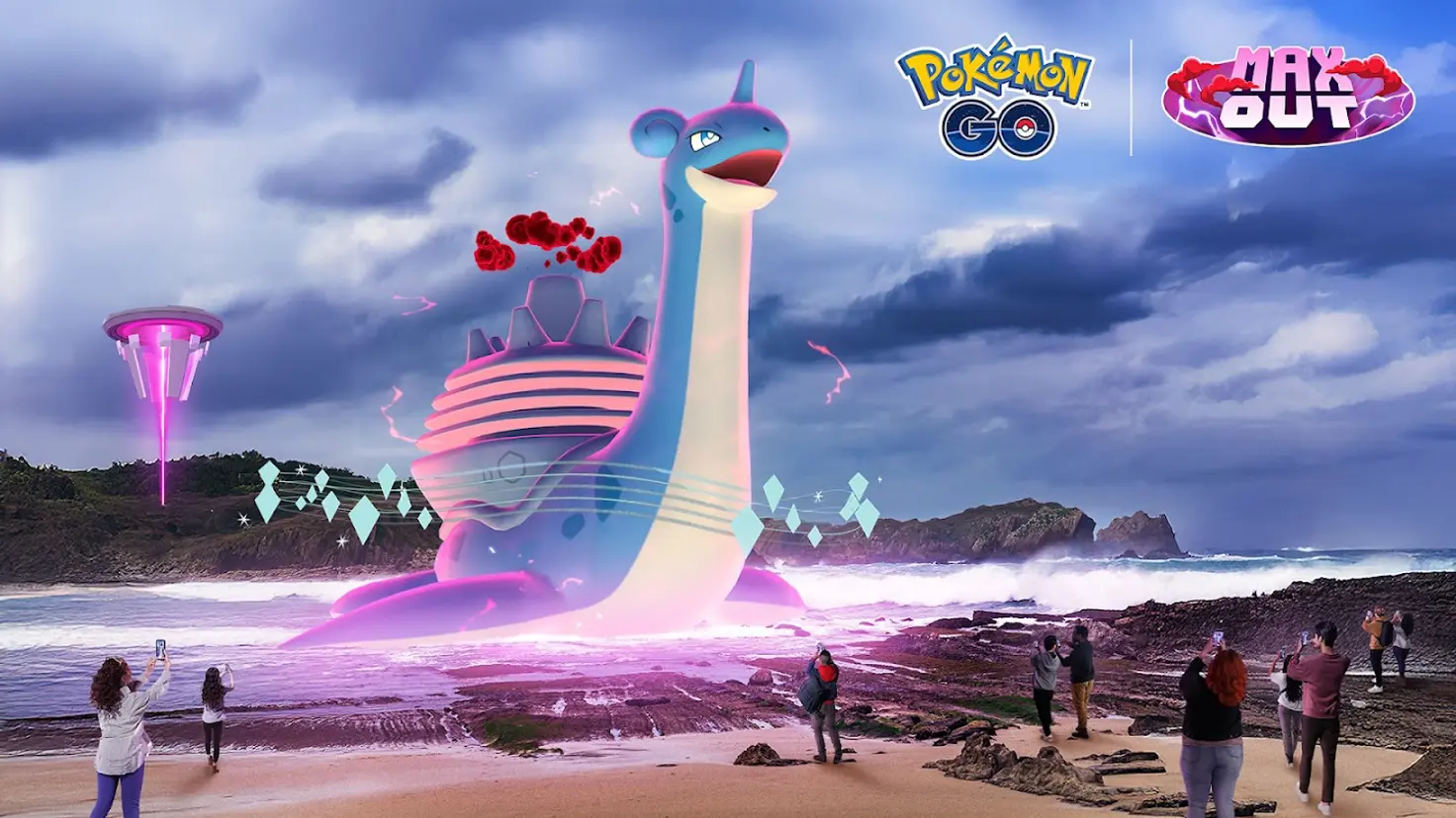 Gigantamax Lapras in the water near a rocky beach. Pokemon Go players on the beach point their smartphones cameras at Lapras.