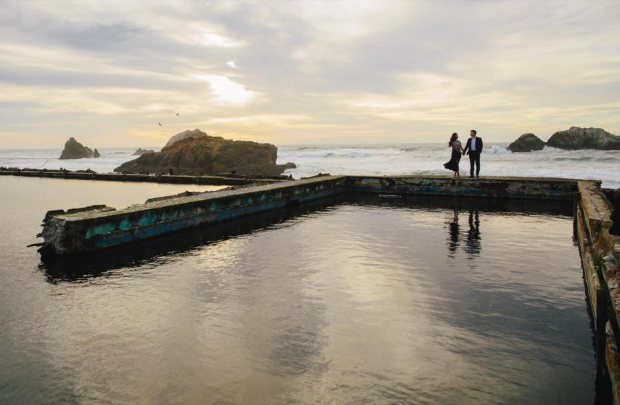 Tammy and Sang at the edge of the Sutro Baths ruins with the Pacific behind them.