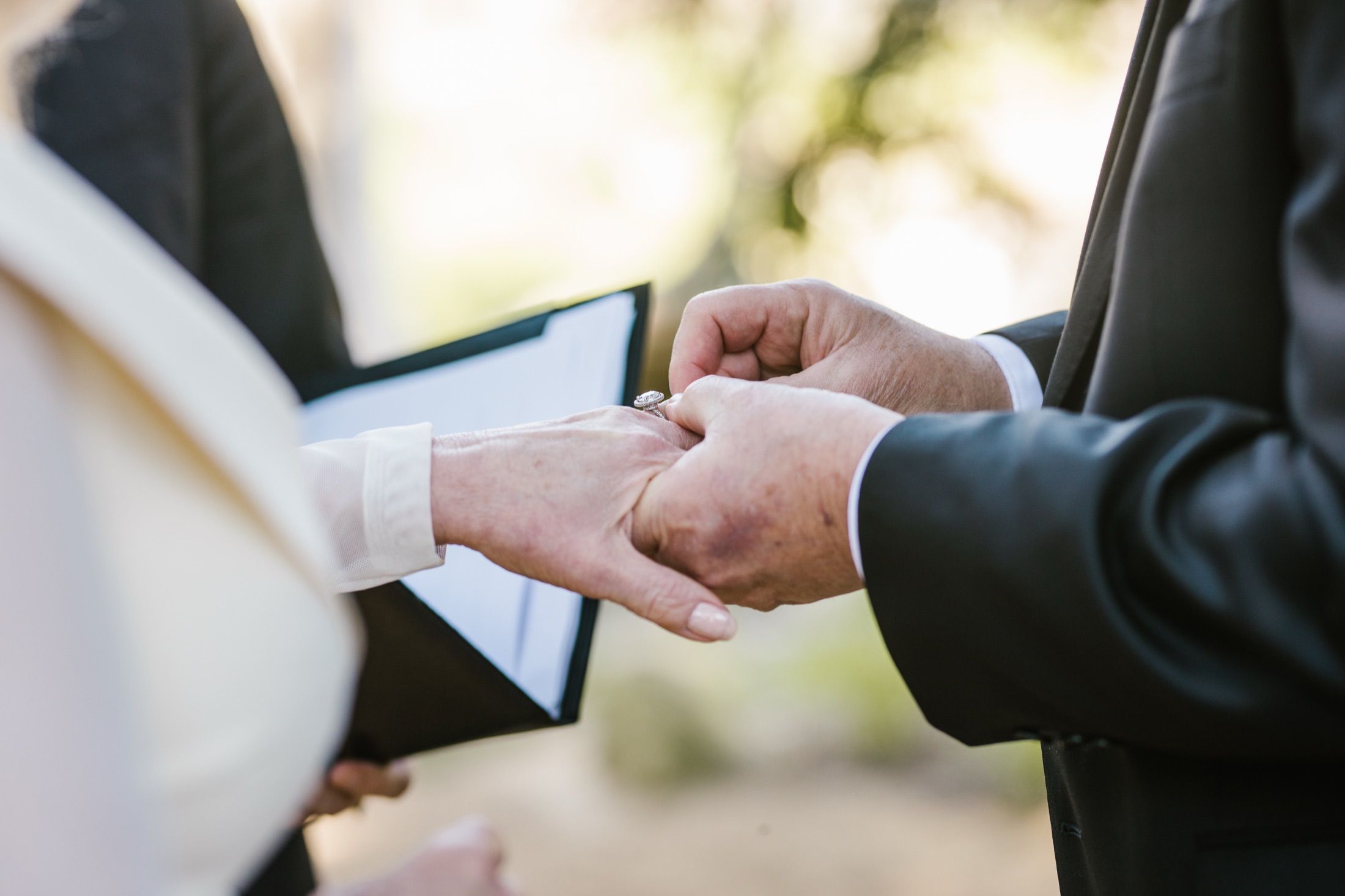 Hands during the ring exchange — Lisa and Jim's wedding day.