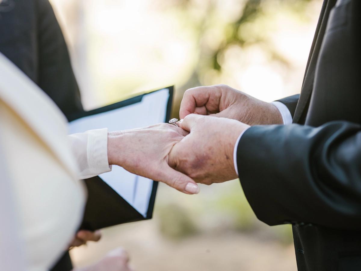 Hands during the ring exchange — Lisa and Jim's wedding day.