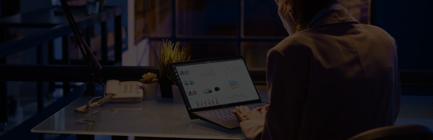 Person working at a desk with multiple monitors