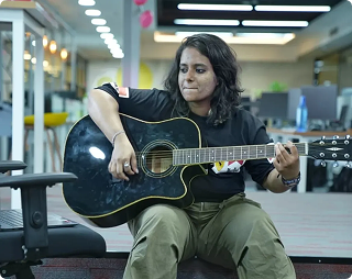 Team member playing guitar