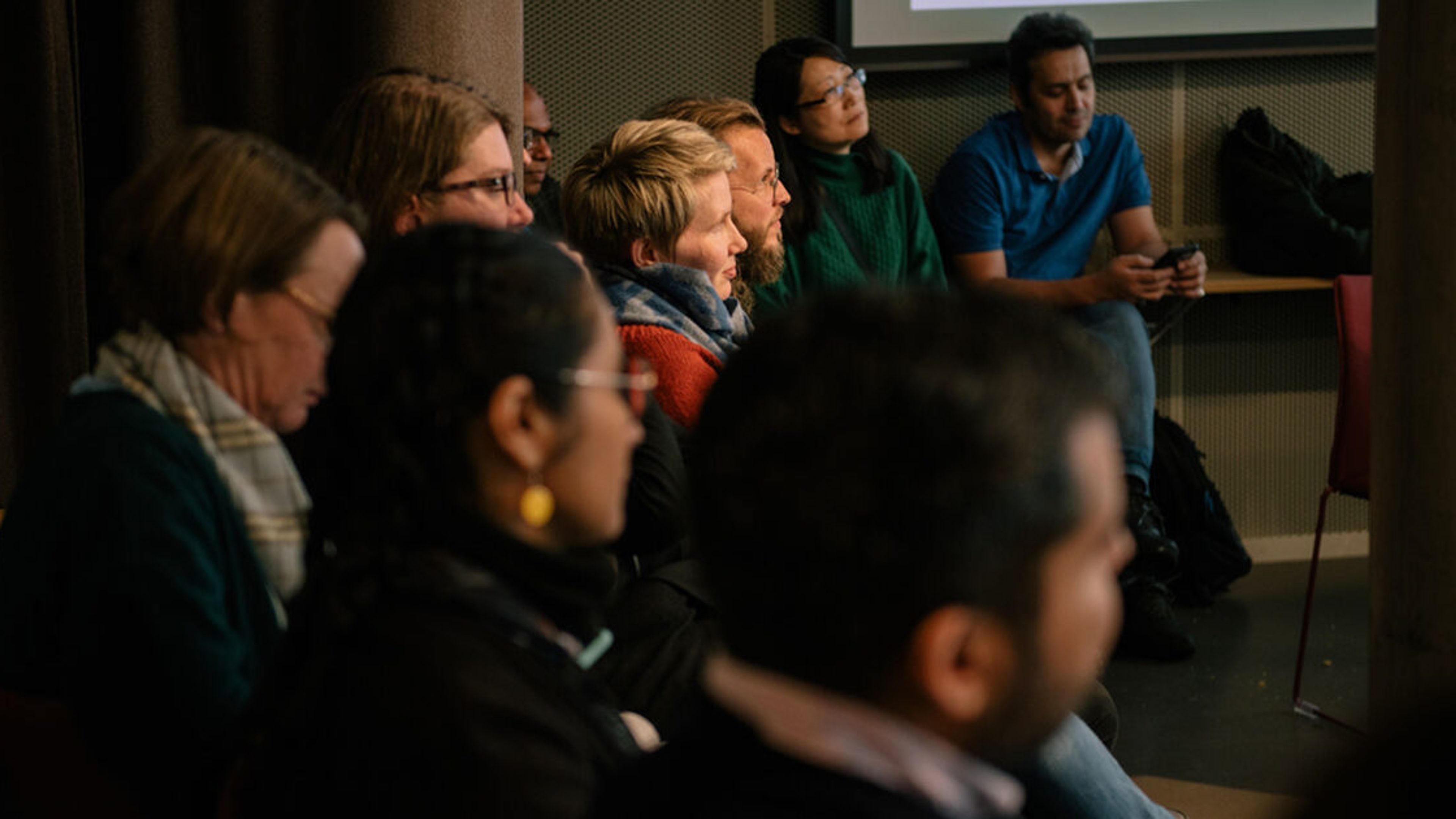 An audience seated in rows listening to a talk