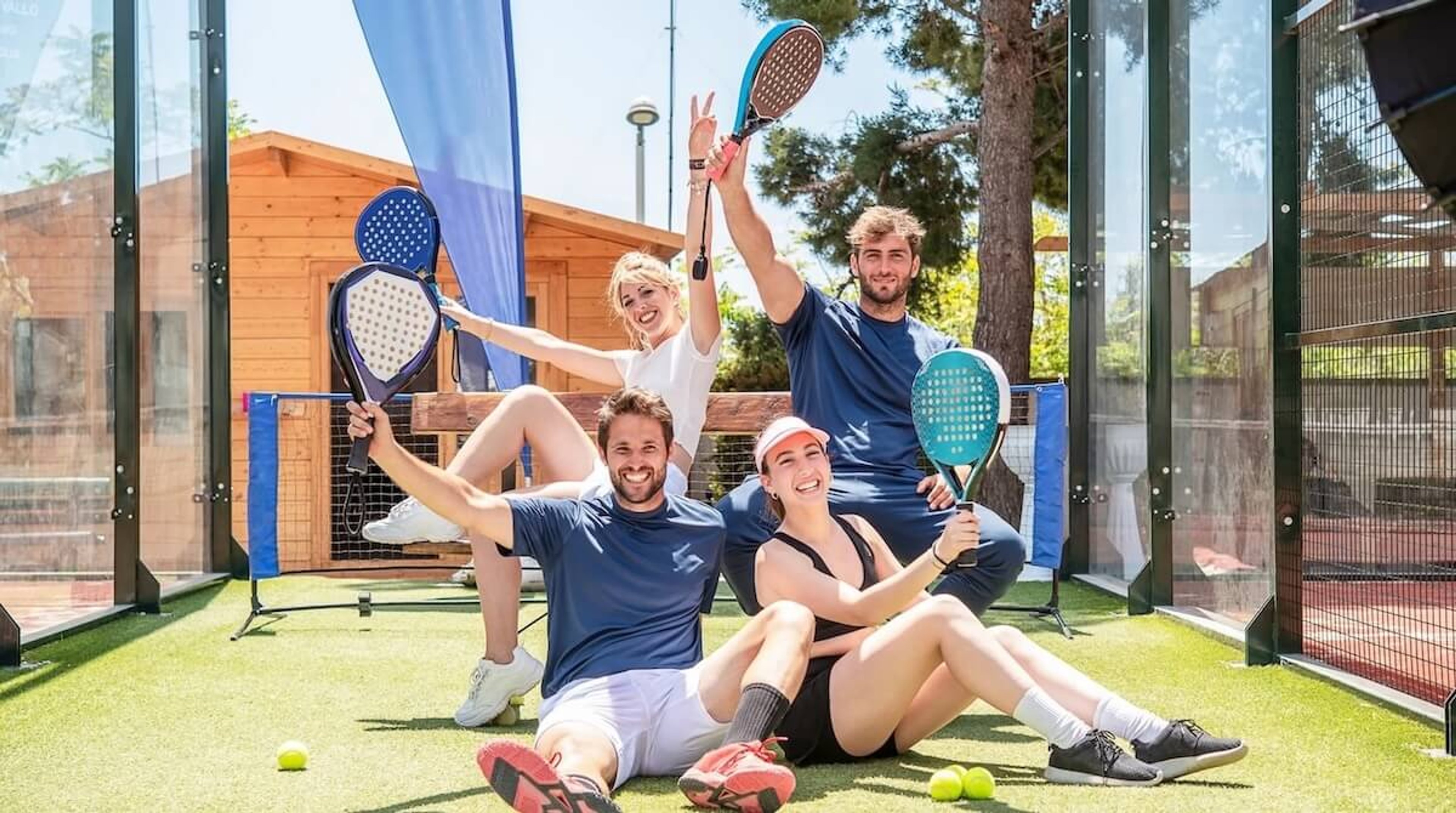 A group of friends posing on a padel court