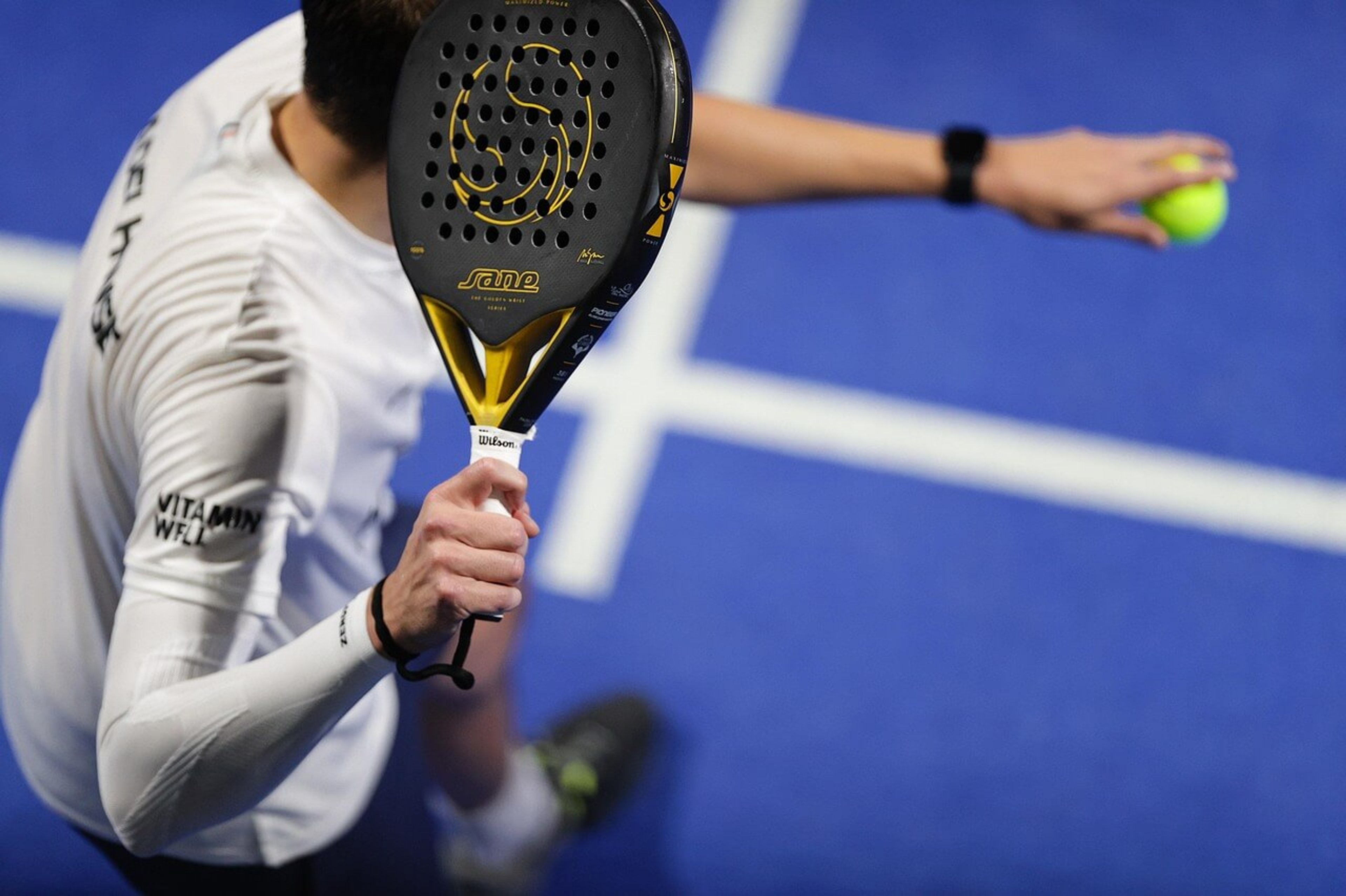 Padel player serving