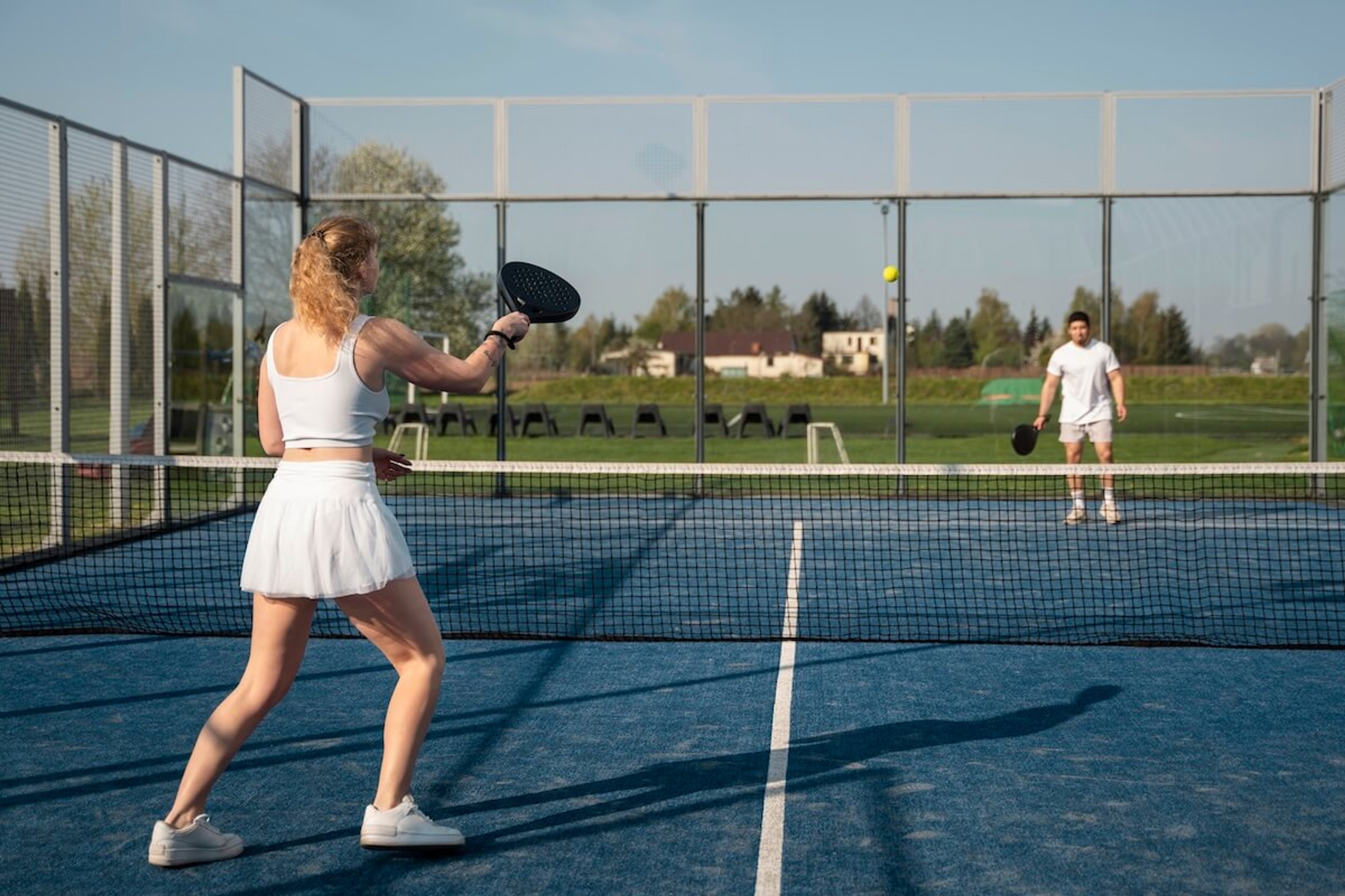 People playing padel on outside court
