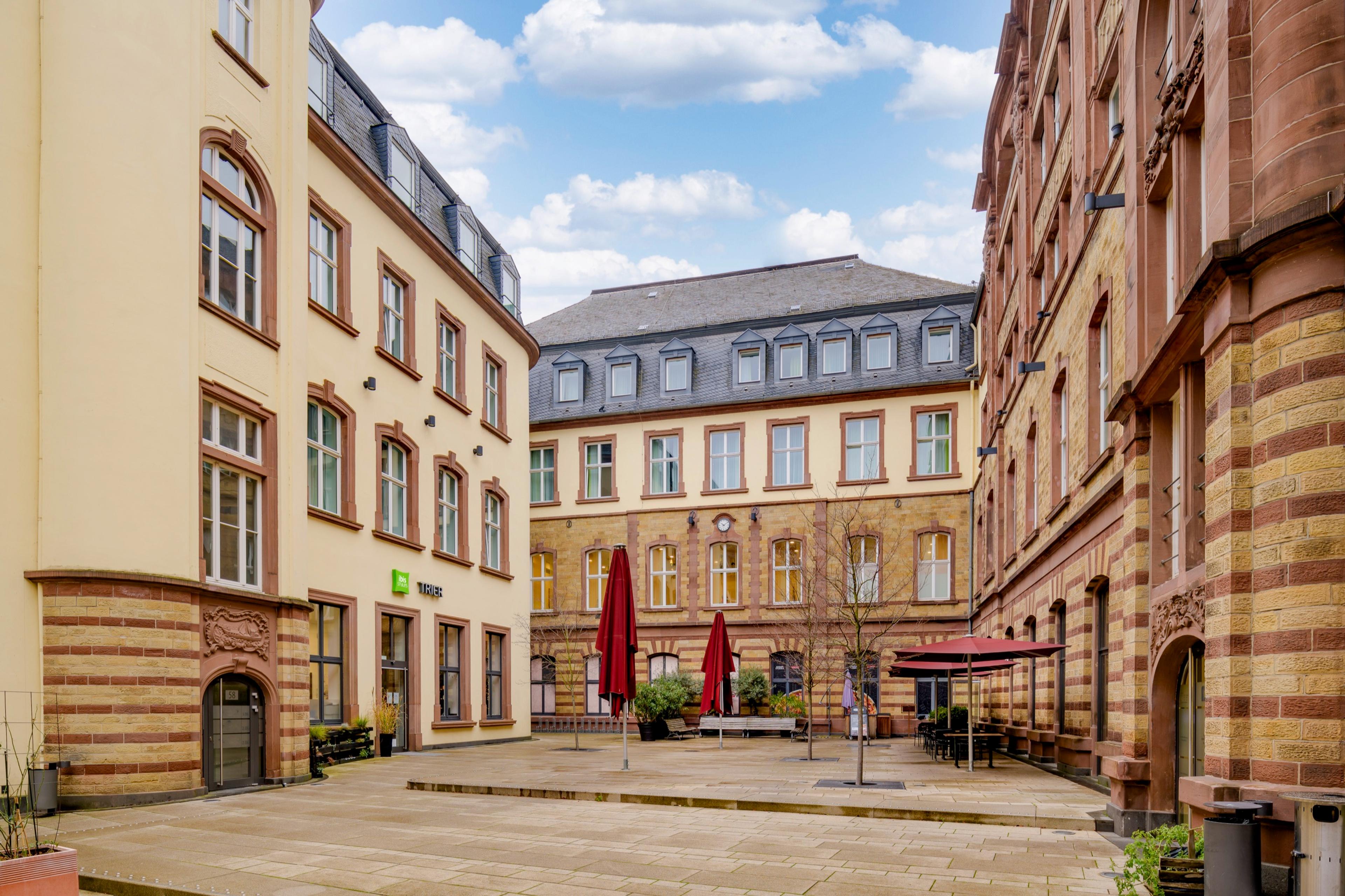 Innenhof des historischen Posthofs in Trier bei Tag mit Außenterrasse