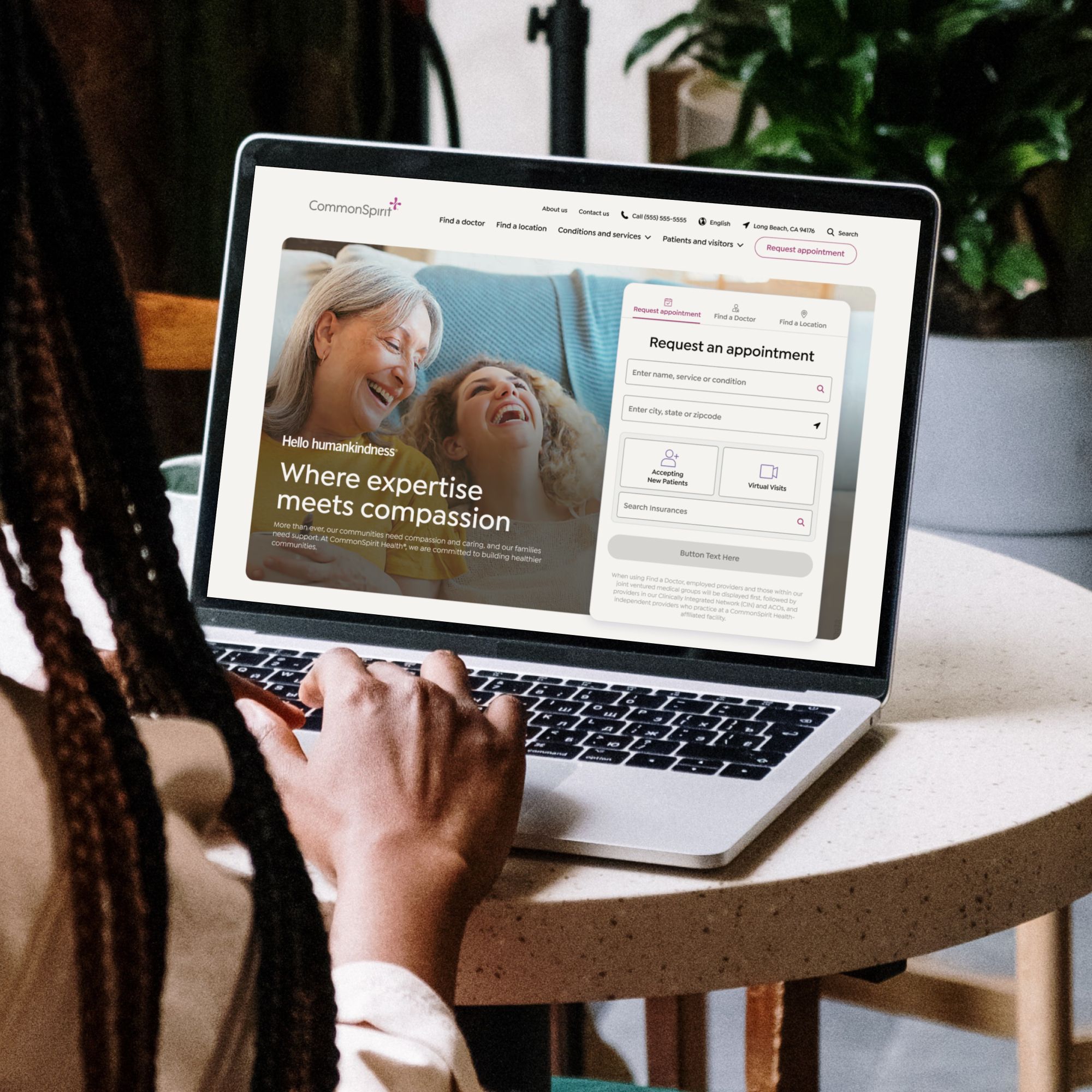 Person using a laptop showing the CommonSpirit Health website and appointment request experience.