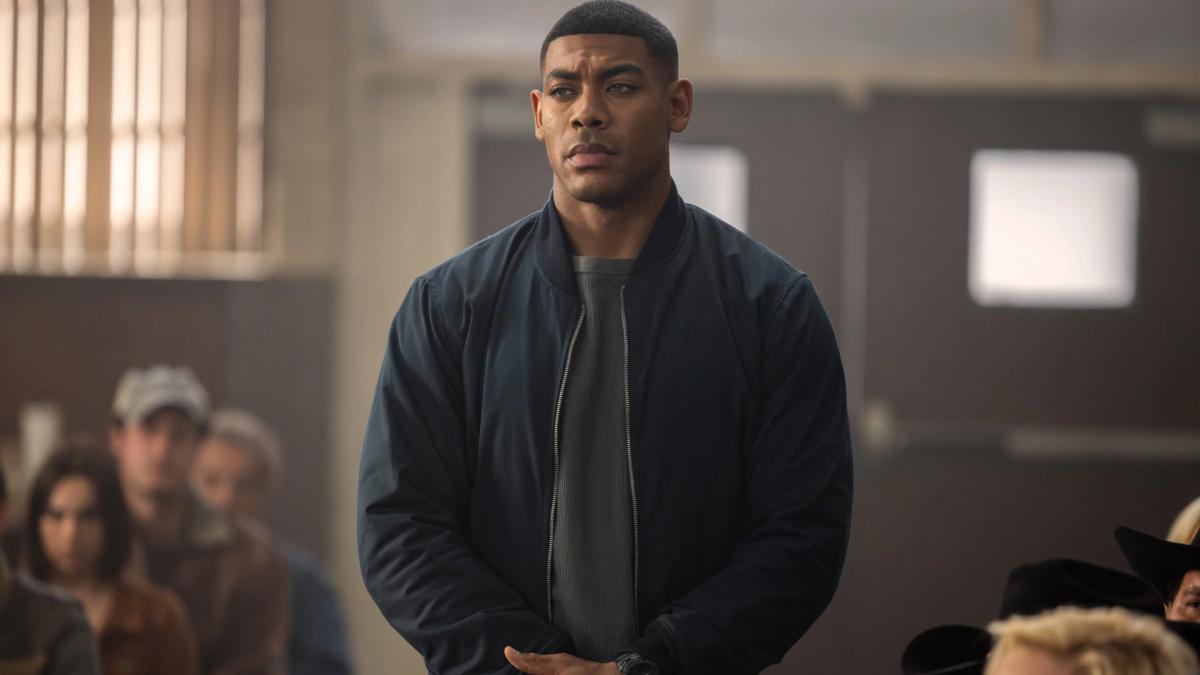 Aaron Pierre as John Stewart standing in a Nebraska courthouse in Lanterns episode 1