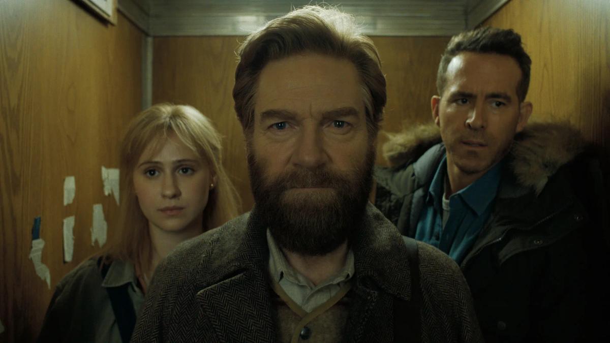 Maria Bakalova as Anna Ustinov, Kenneth Branagh as Nikolai Ustinov and Ryan Reynolds as Troy Kelly crowded into a lift