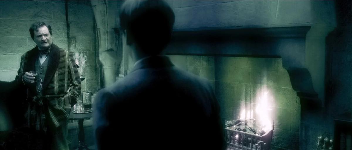 Jim Broadbent as Horace Slughorn speaking with Frank Dillane as Tom Riddle inside a memory