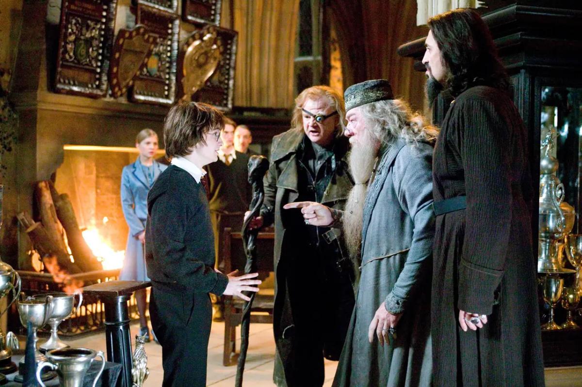 Brendan Gleeson as Alastor Moody points at Daniel Radcliffe as Harry Potter beside Michael Gambon as Albus Dumbledore after the Goblet picks Harry’s name.
