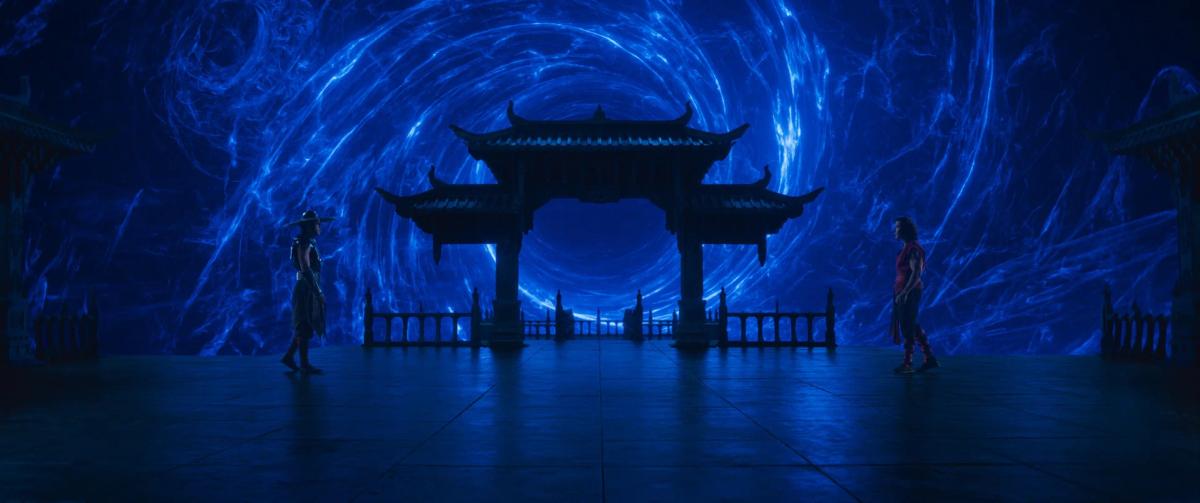Two fighters face each other on a stone platform beneath a tiered gate, with a swirling blue portal filling the sky behind them.