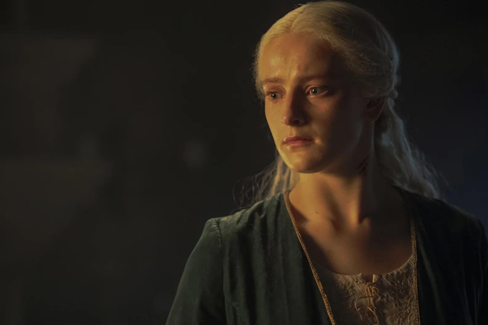 Phia Saban as Helaena Targaryen, close on her face, eyes wet, in a dark room