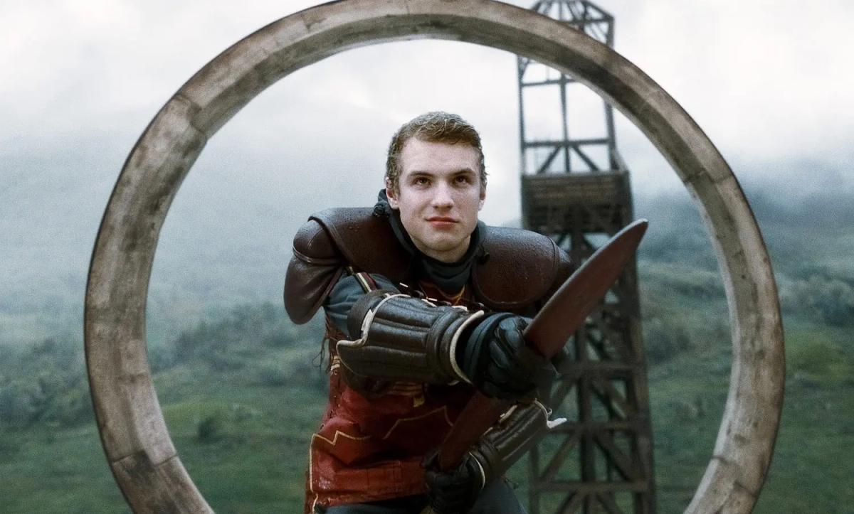Freddie Stroma as Cormac McLaggen guarding a goal hoop during a Quidditch match