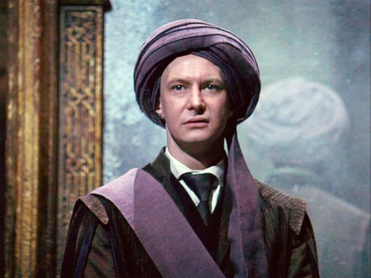 Professor Quirrell (Ian Hart) in his turban, standing in front of the Mirror of Erised.