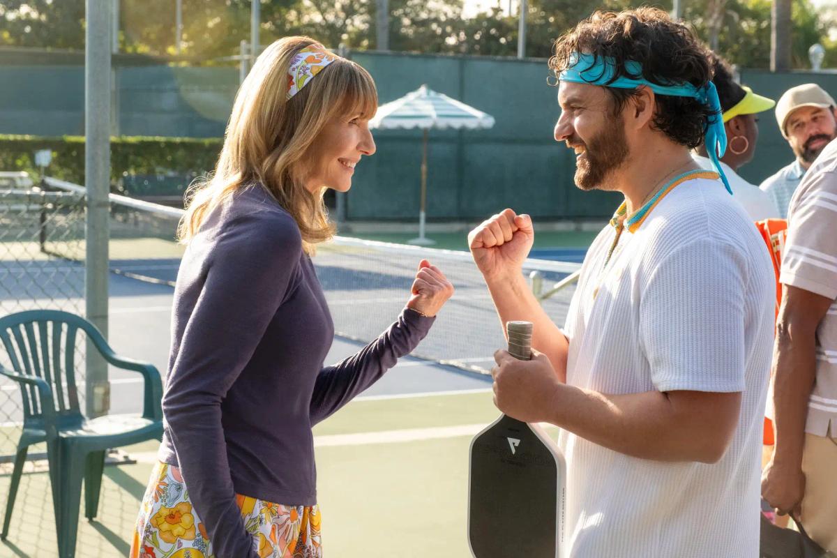 Candace (Mary Steenburgen) and Dusty Boyd (Jake Johnson) face each other with clenched fists on a pickleball court.