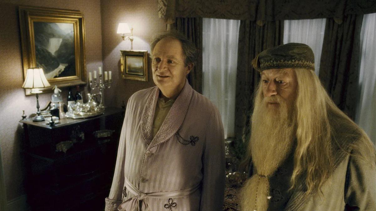 Jim Broadbent as Horace Slughorn and Michael Gambon as Albus Dumbledore standing together after Slughorn abandons his armchair disguise
