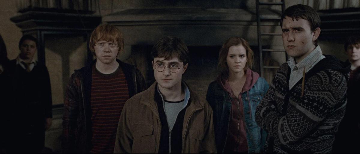 Matthew Lewis as Neville Longbottom welcomes Daniel Radcliffe as Harry Potter, Rupert Grint as Ron Weasley and Emma Watson as Hermione Granger in the Room of Requirement.