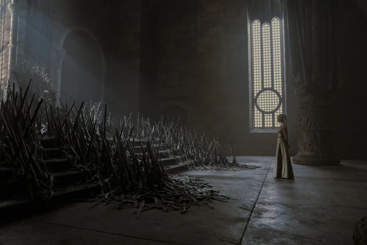 The Iron Throne in a dim hall, swords spilling down the steps, a lone figure standing at a tall window