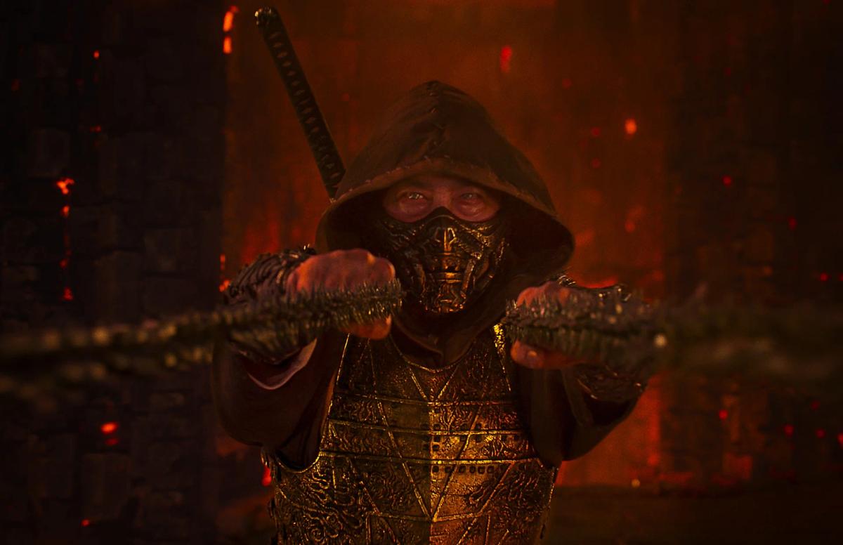 Hiroyuki Sanada as Scorpion, hooded and masked, pulling a chain taut between his hands.