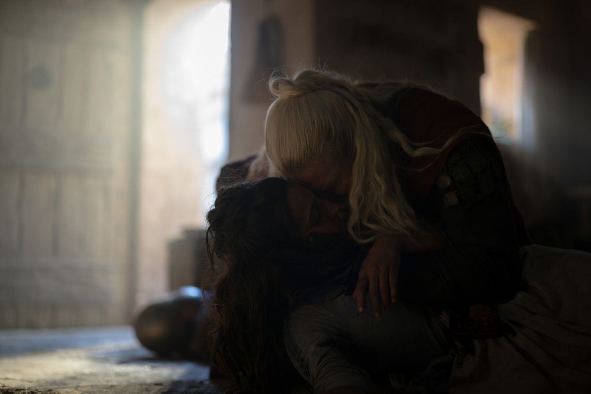 Hugh Hammer kneeling over Kat's body inside her brother's house, holding her