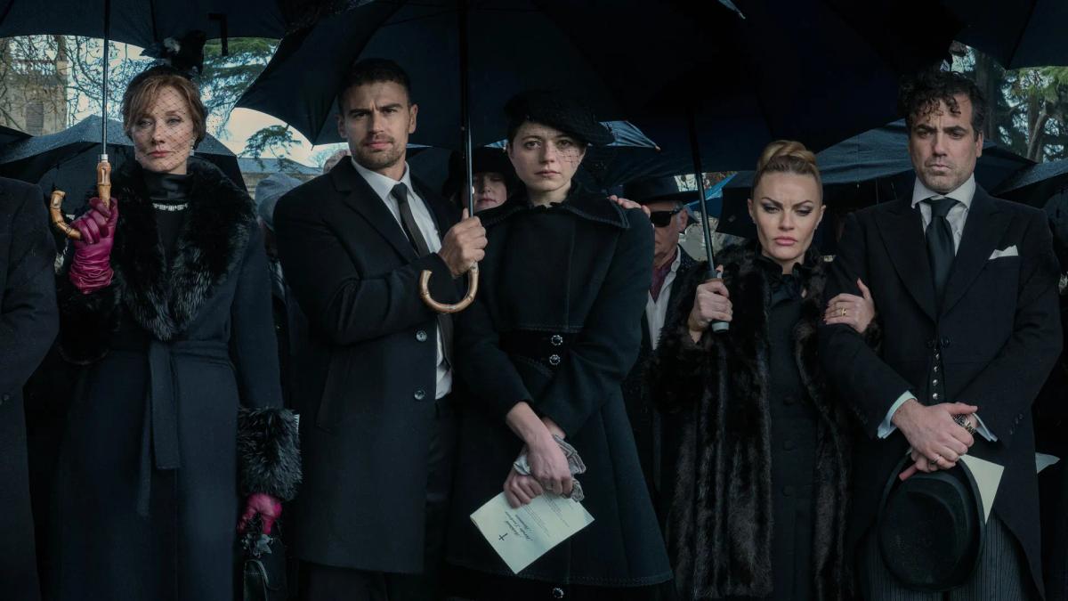 The Horniman family at the late Duke's funeral in the rain, under black umbrellas.
