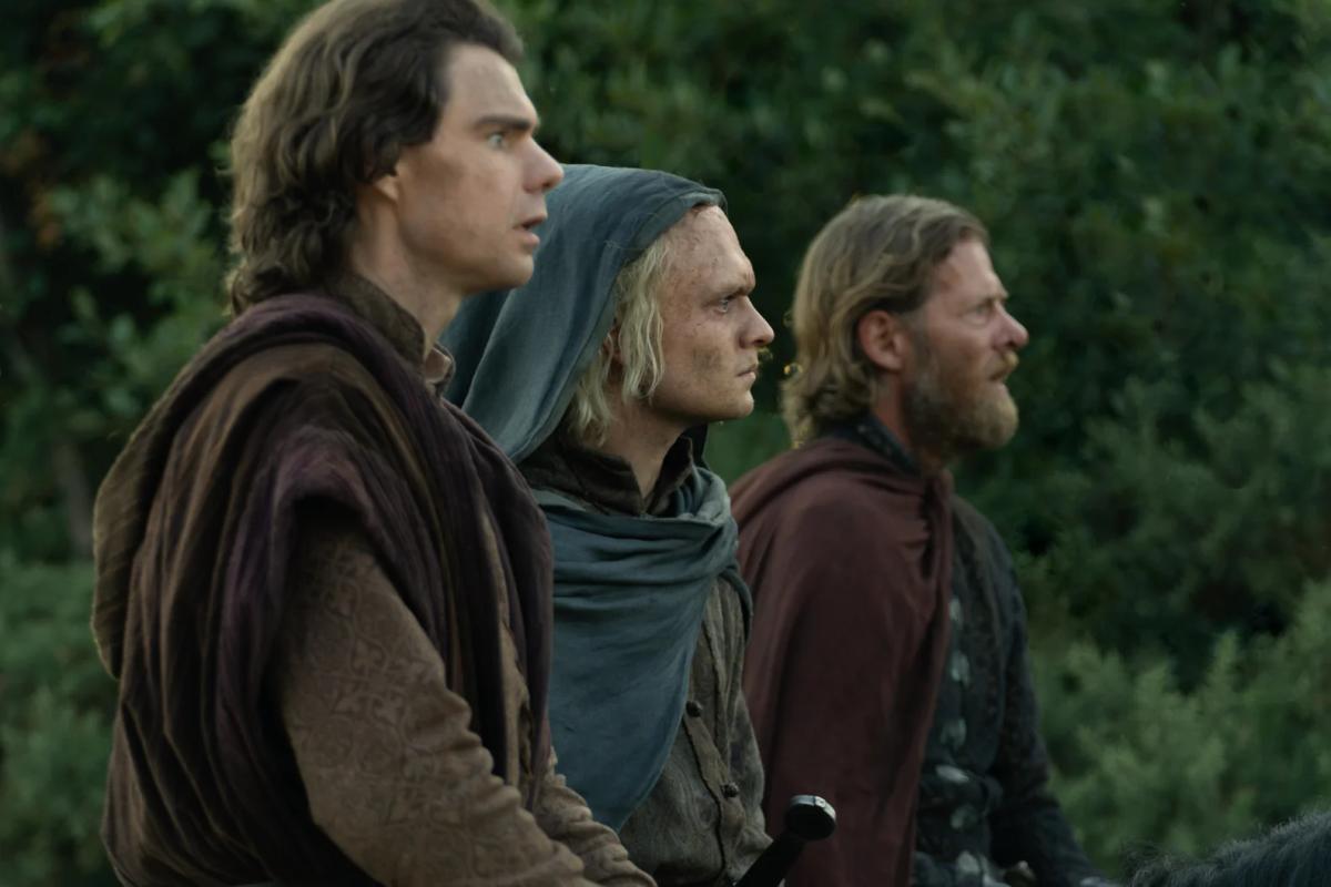 Matthew Needham as Larys Strong, Tom Glynn-Carney as a hooded Aegon II and Jefferson Hall as Tyland Lannister riding together
