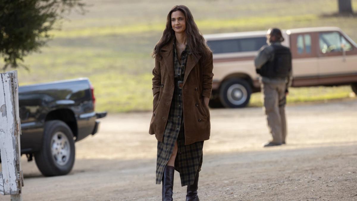 Poorna Jagannathan as Zoe Macon walking across the Macon ranch in Lanterns episode 1