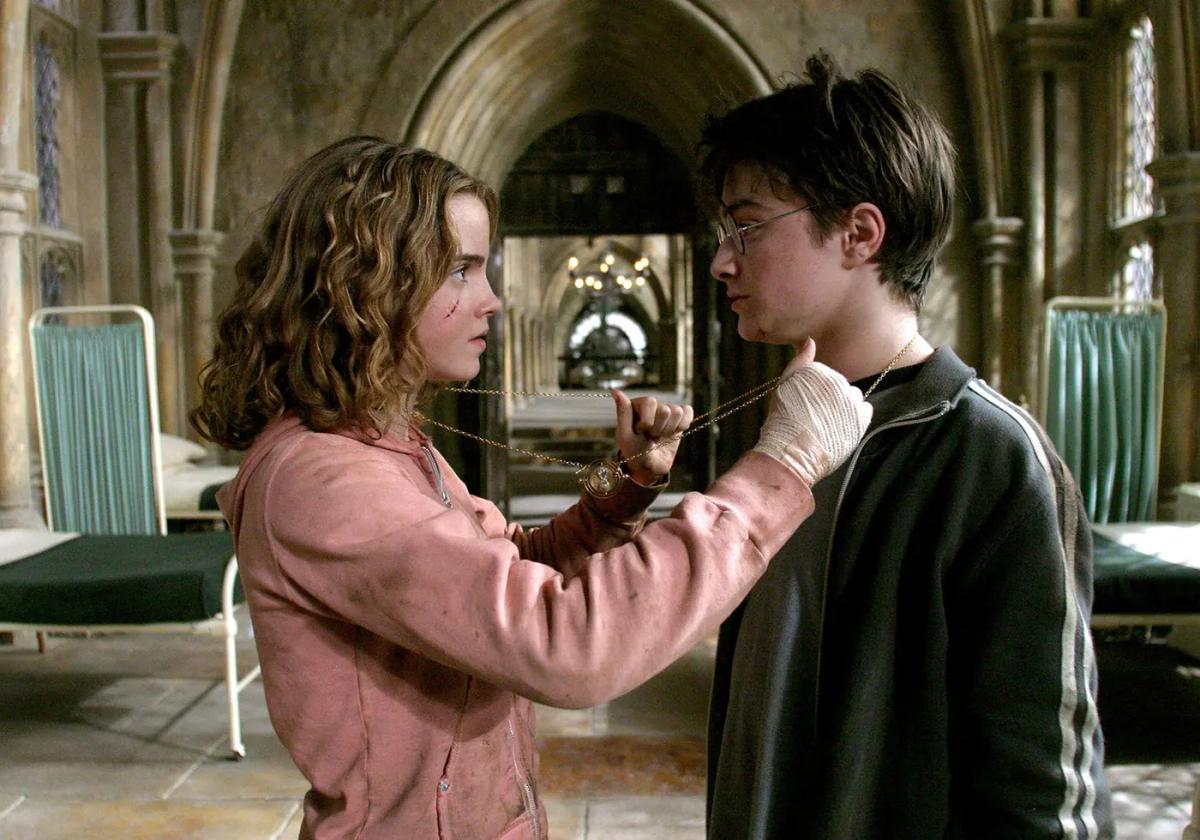 Emma Watson as Hermione Granger placing the Time-Turner chain around Daniel Radcliffe as Harry Potter in the hospital wing