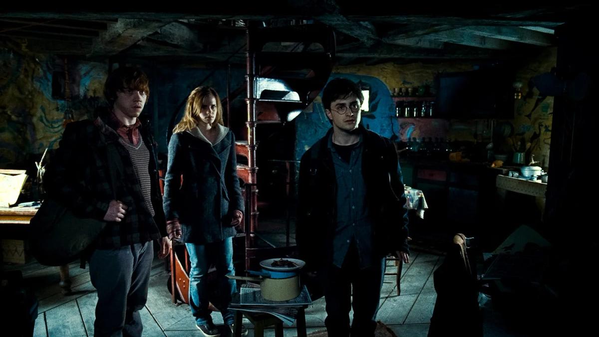 Rupert Grint as Ron Weasley, Emma Watson as Hermione Granger and Daniel Radcliffe as Harry Potter inside Xenophilius Lovegood’s house