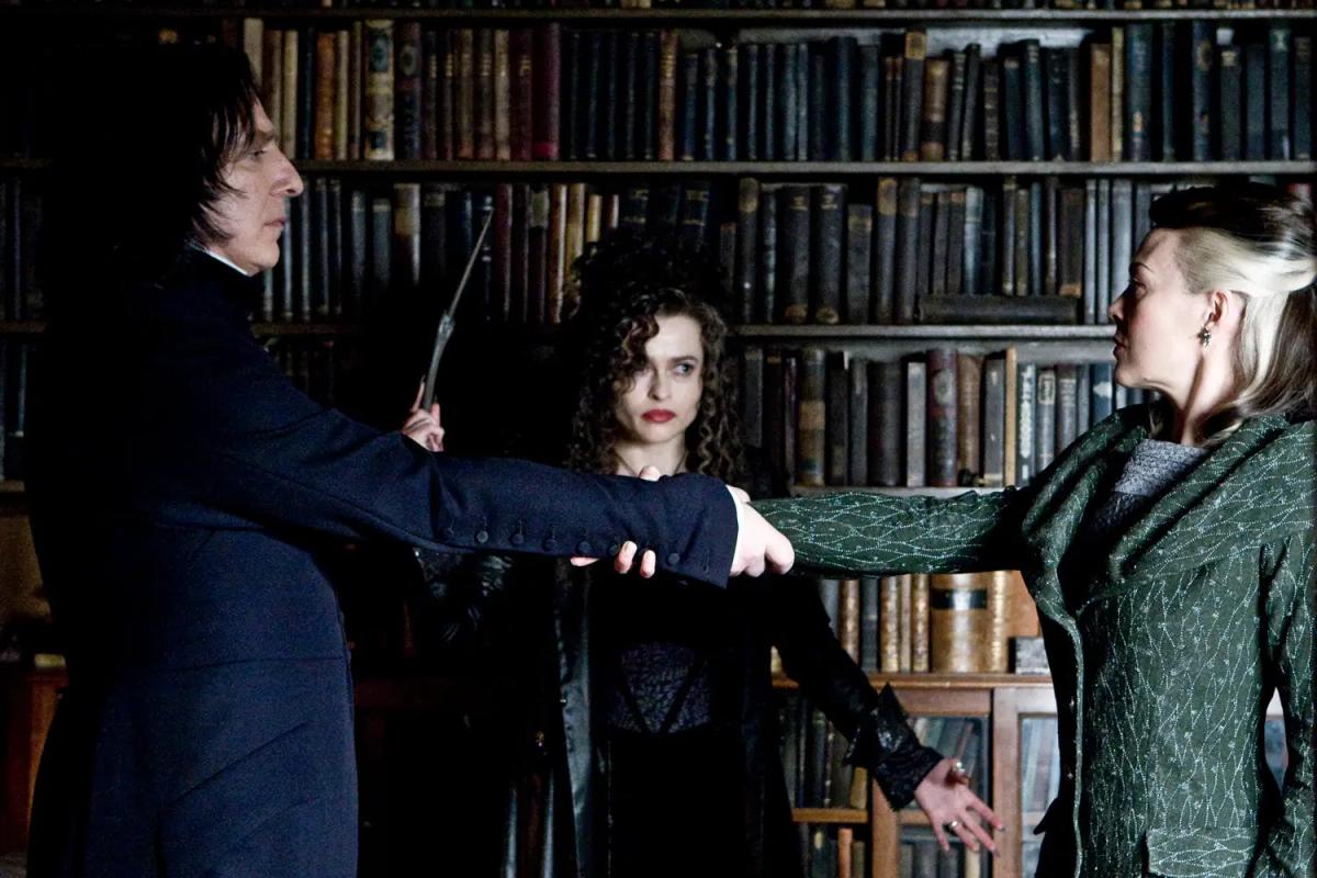 Alan Rickman as Severus Snape and Helen McCrory as Narcissa Malfoy joining hands for the Unbreakable Vow while Helena Bonham Carter as Bellatrix Lestrange binds them