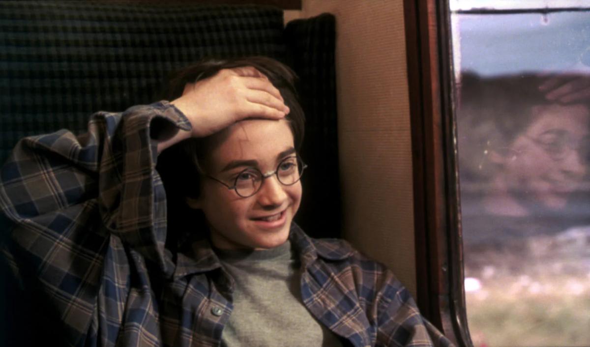 Daniel Radcliffe as Harry Potter looks out from a Hogwarts Express window.
