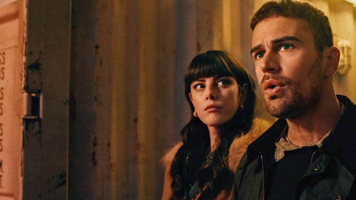 Kaya Scodelario as Susie Glass and Theo James as Eddie Horniman standing close together behind a door frame, both looking off to one side.