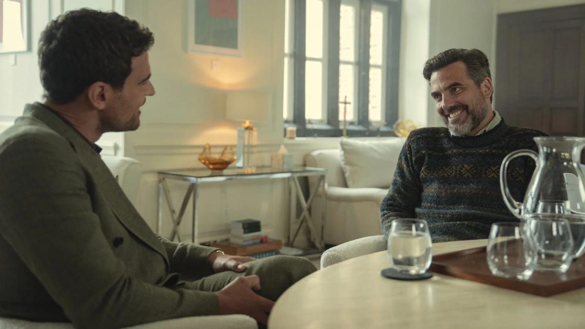 Theo James as Eddie Horniman sitting opposite Daniel Ings as Freddy Horniman in a bright rehab common room, Freddy bearded and laughing.