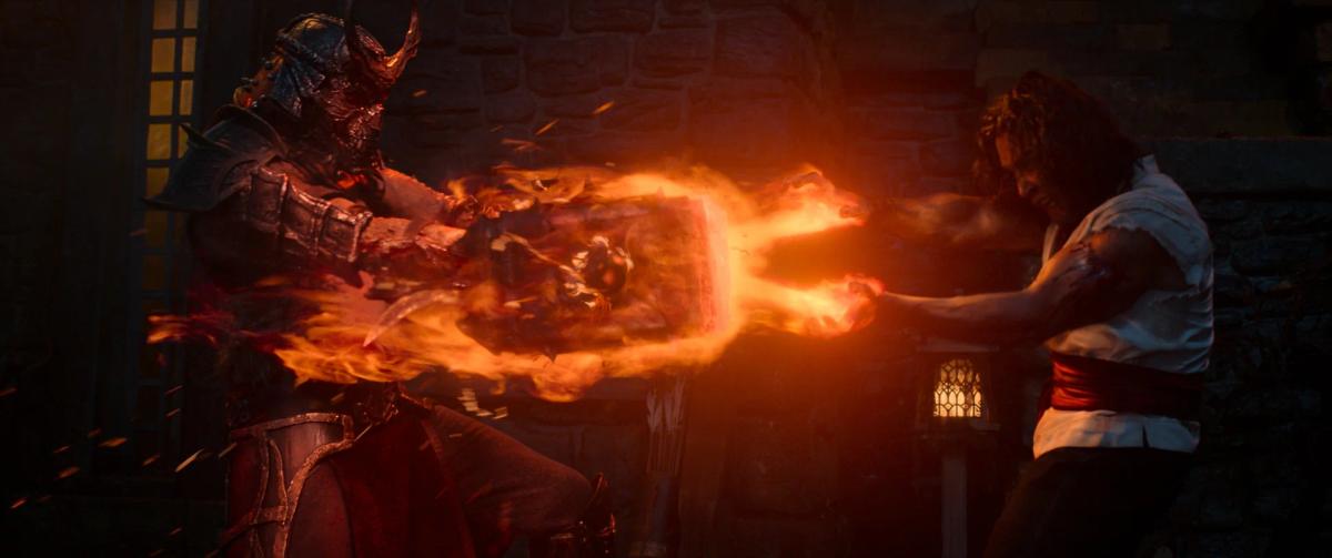 Martyn Ford as Shao Kahn and Ludi Lin as Liu Kang, locked together by a blazing ring of fire.