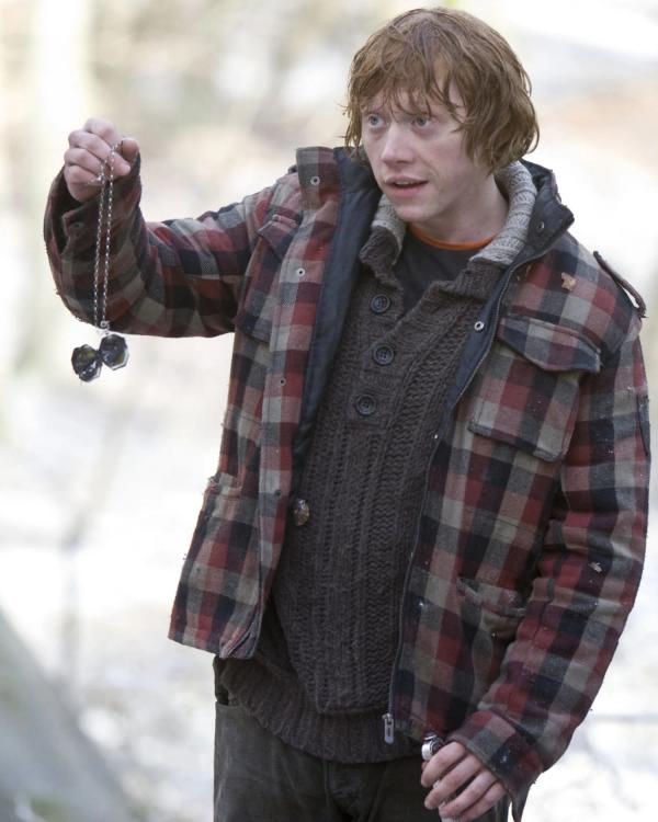 Rupert Grint as Ron Weasley holds the open locket after its destruction.