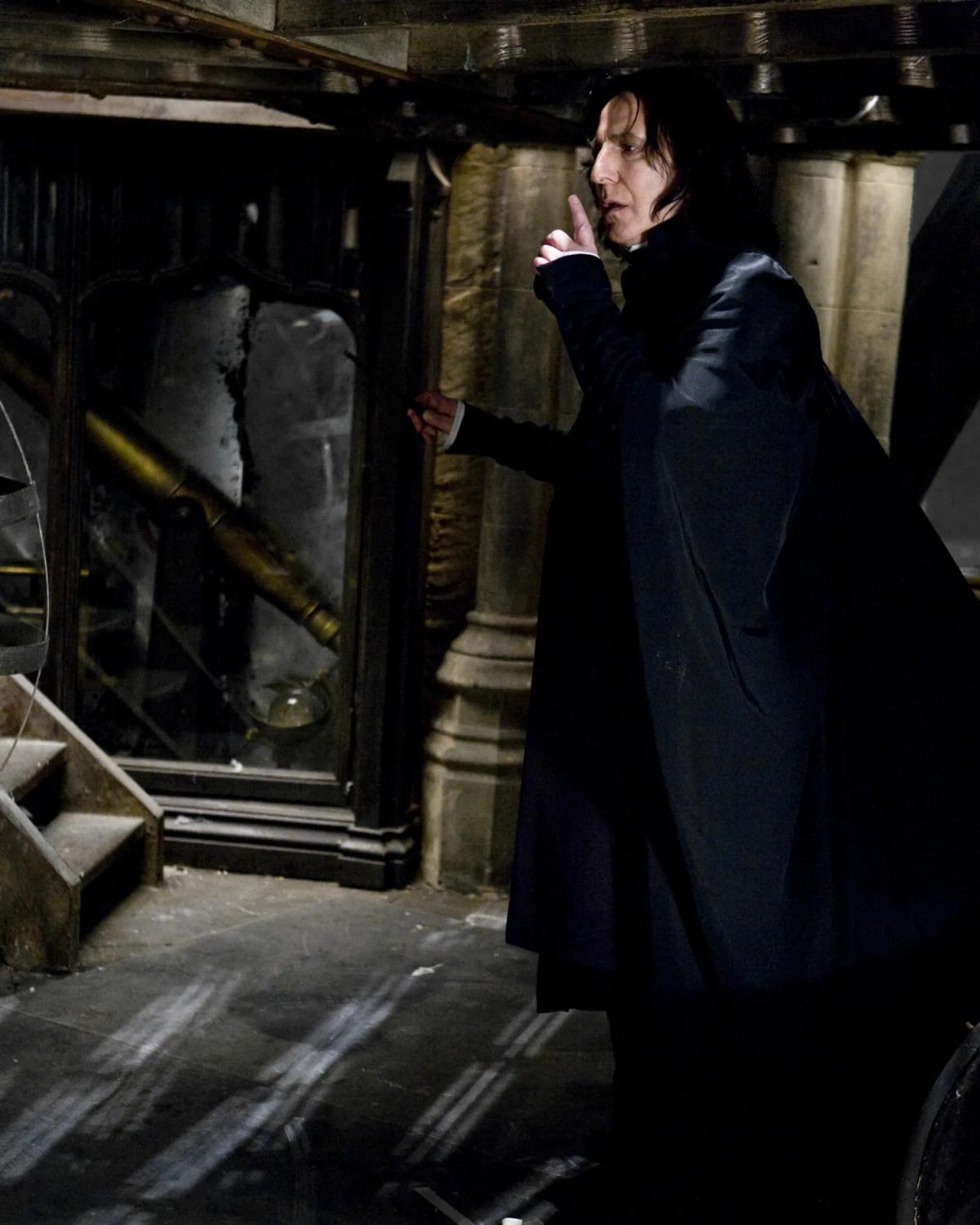 Alan Rickman as Severus Snape raises a finger to his lips on the Astronomy Tower.
