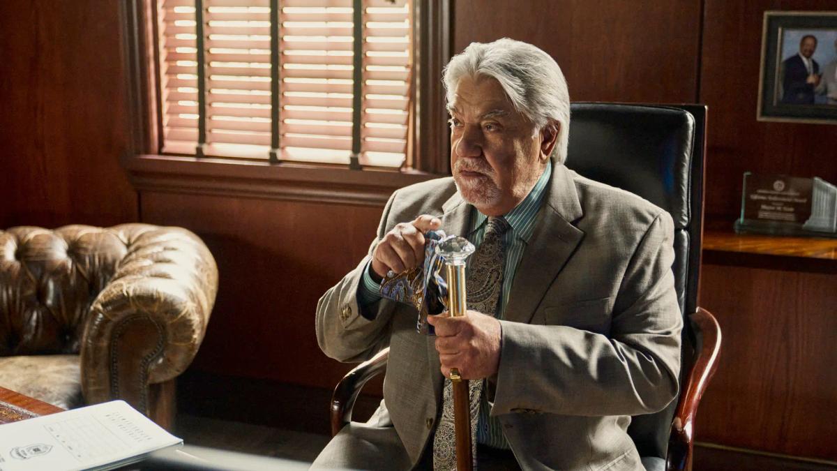 Bruce McGill as Mayor Grover Teale sits in a leather chair in a wood-panelled office, both hands resting on the head of a walking cane.