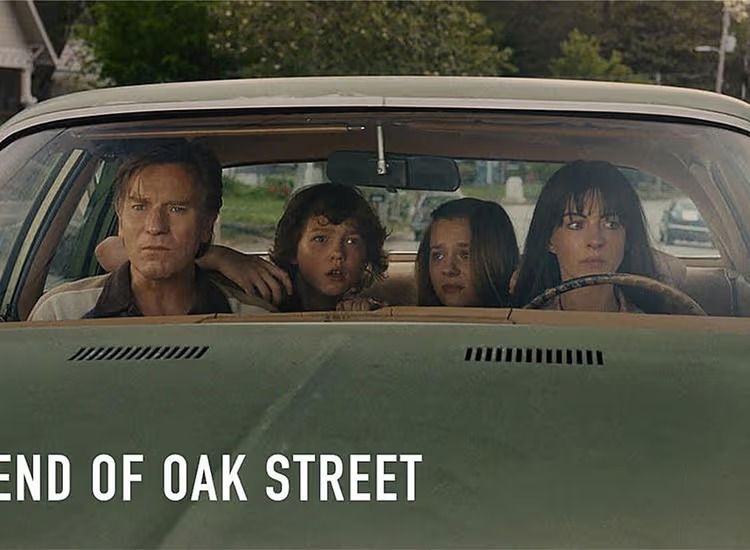 Greg, Brian, Audrey and Denise Platt crammed into the front of a station wagon, all four staring ahead through the windscreen