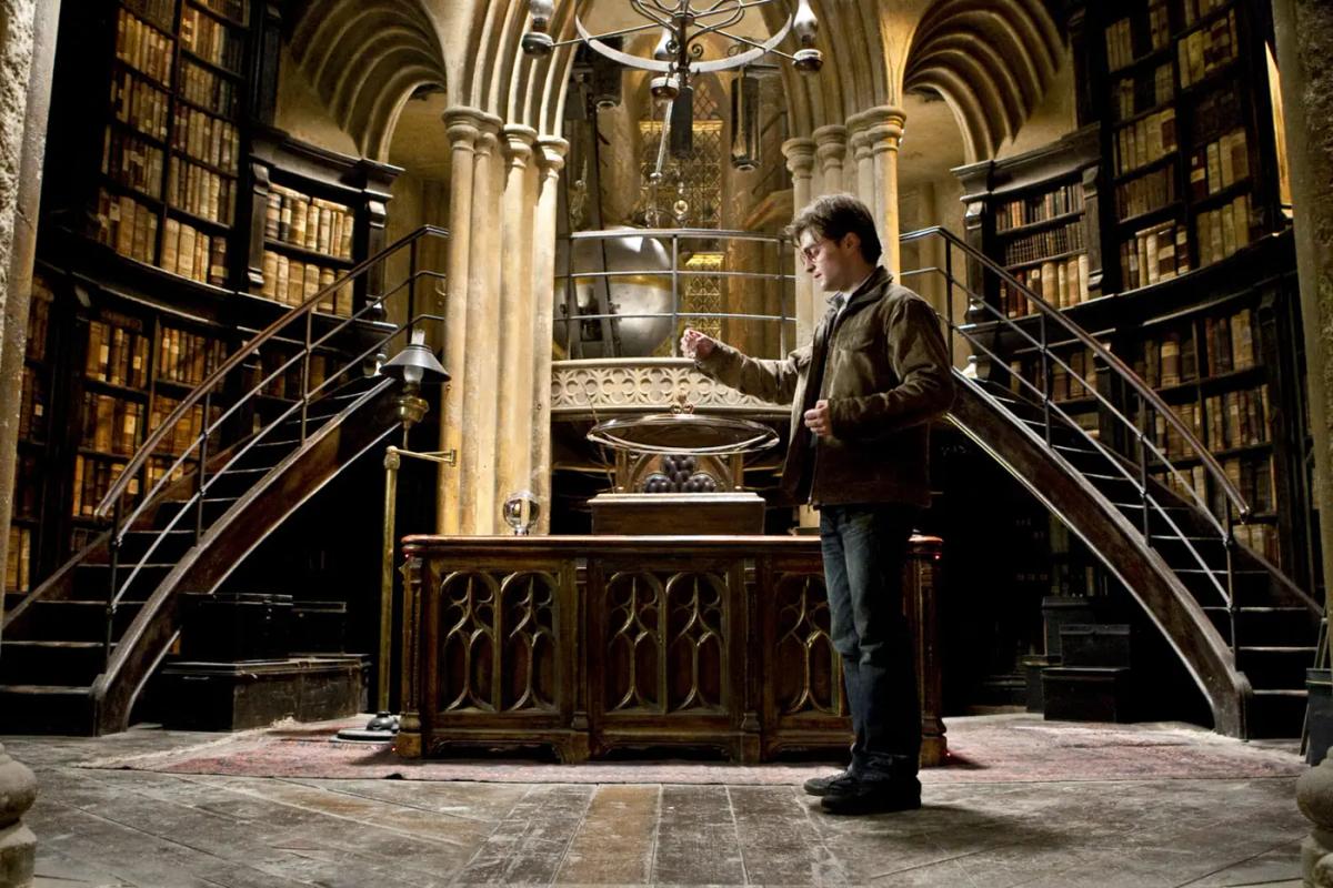 Daniel Radcliffe as Harry Potter carrying Severus Snape’s memories to the Pensieve in Dumbledore’s office