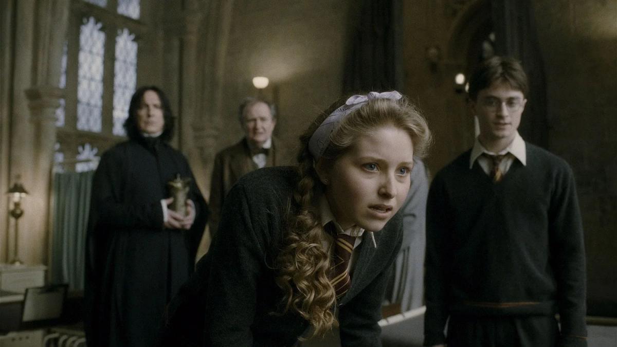 Jessie Cave as Lavender Brown leaning towards Ron’s bedside, with Alan Rickman as Severus Snape, Jim Broadbent as Horace Slughorn and Daniel Radcliffe as Harry Potter behind her in the hospital wing